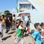 Pupils of the Second Futenma Elementary School carry out an evacuation drill for a possible helicopter crash