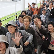 One hundred people currently living in temporary housing in Fukushima arrive in Okinawa
