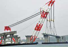 Giant crane ship lifts down a 140-meter long and 1300-ton box girder onto the Irabu-Ohashi Bridge