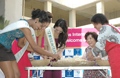 Miss International contestants race against locals removing bean sprouts roots