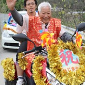Ninety-six year-old motorcycle rider parades in celebration