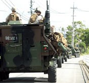 U.S. military vehicles enter restricted road