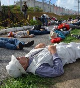Nine years since U.S. helicopter crash onto Okinawa International University: Protesters stage a “die-in rally” in front of Marine base