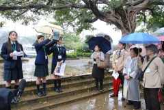 High school students guide explaining Japanese schoolgirls who worked for the Imperial Japanese Army during Battle of Okinawa