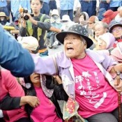 Eighty-six-year-old Fumiko Shimabukuro takes a stand in front of Camp Schwab
