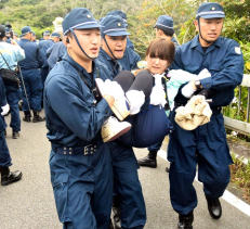 Riot police officers forcibly remove protestors on the morning of August 22 in Higashi Village, Takae.