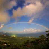 Rainbow in night sky drawing arch of happiness captured in Ishigaki