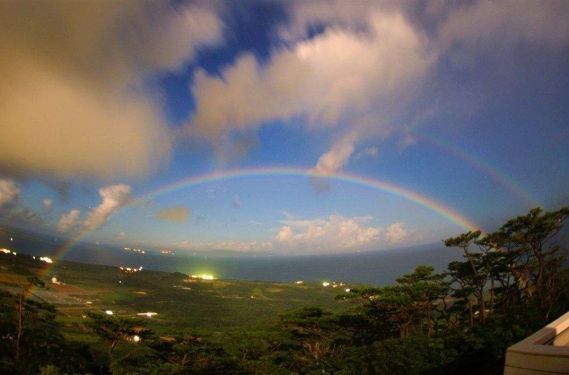 Rainbow in night sky drawing arch of happiness captured in Ishigaki