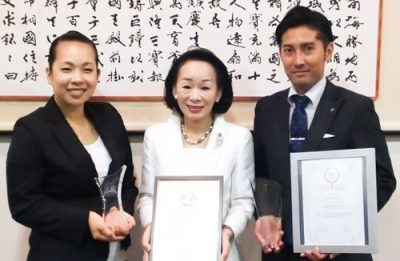 On November 22, 2016, at Ryukyu Shimpo, Owner Miki Fuchibe (middle), Sub manager Kayoko Ikeda (left), and Yasuto Morishima Sales Manager hold the World Boutique Hotel Award and a plaque. 