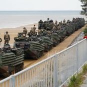 U.S. military amphibious vehicles cross highway in Ginoza, stopping traffic