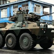 GSDF armored vehicle seen driving along National Route 58 with machine gun uncovered