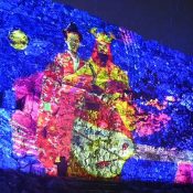 Hokuzan king makes an appearance at Nakijin Castle at night! The world heritage site’s castle wall get a vibrant light-up display
