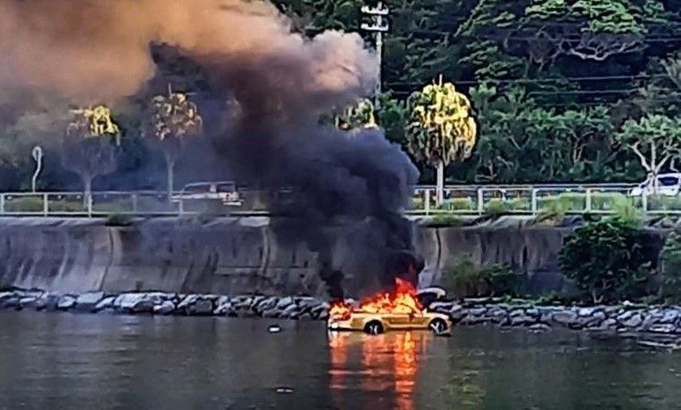 Convertible explodes and catches fire in the ocean after getting stuck in a mudflat