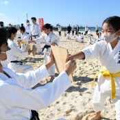Eighty students of all ages join year’s first karate practice on beach
