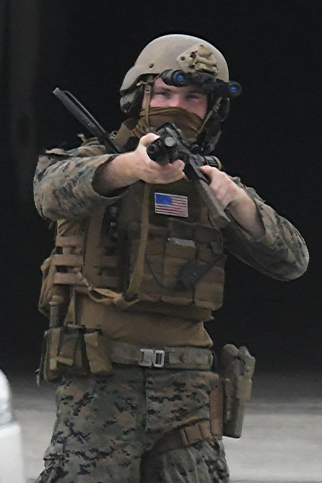 U.S. soldier points muzzle of his gun toward Ryukyu Shimpo reporter during training at Naha Port